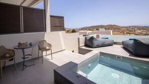 A modern outdoor terrace with a pool, seating, and a view of the landscape. - Blue Pearl Suite in Tinos  (Tinos Town)