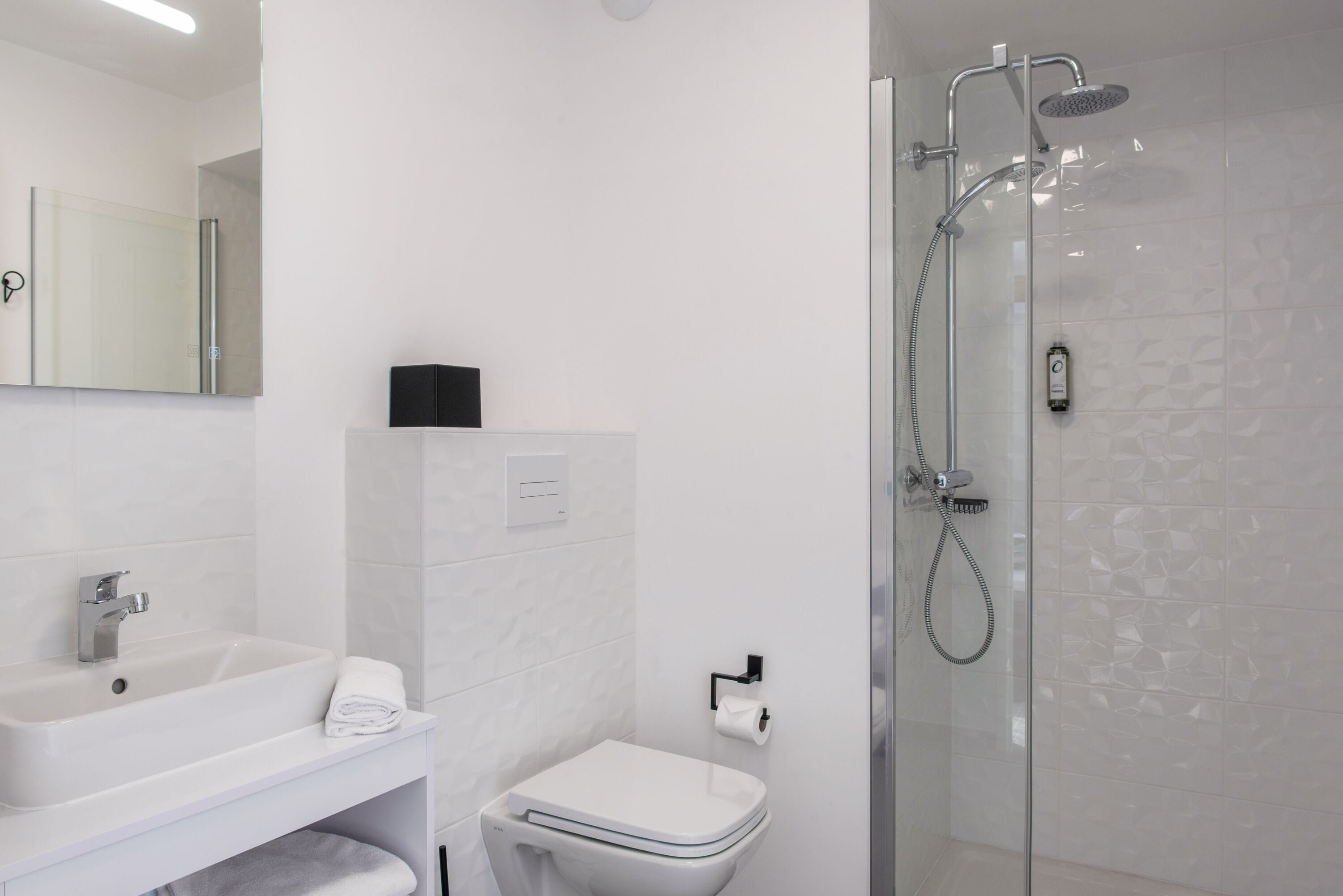 Shower, rainfall showerhead, hair dryer, towels