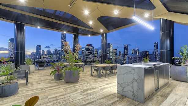 A rooftop terrace with a city skyline view, modern furniture, and potted plants. - The Monterey Apartments by Urban Rest (Kangaroo Point)