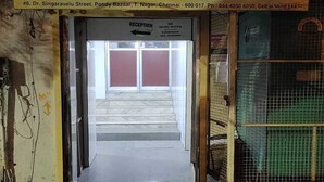 A hotel entrance with a sign for Sri BKM Guest Rooms. - Aayush Residency (Chennai)