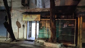 A building with a sign for "Sri Bhan Guest Rooms" indicating luxury rooms are available. - Aayush Residency (Chennai)