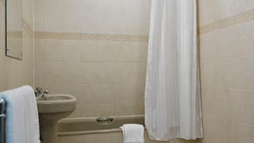 A bathroom with a bathtub, sink, and toilet.