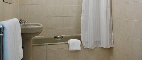 A bathroom with a bathtub, sink, and toilet.
