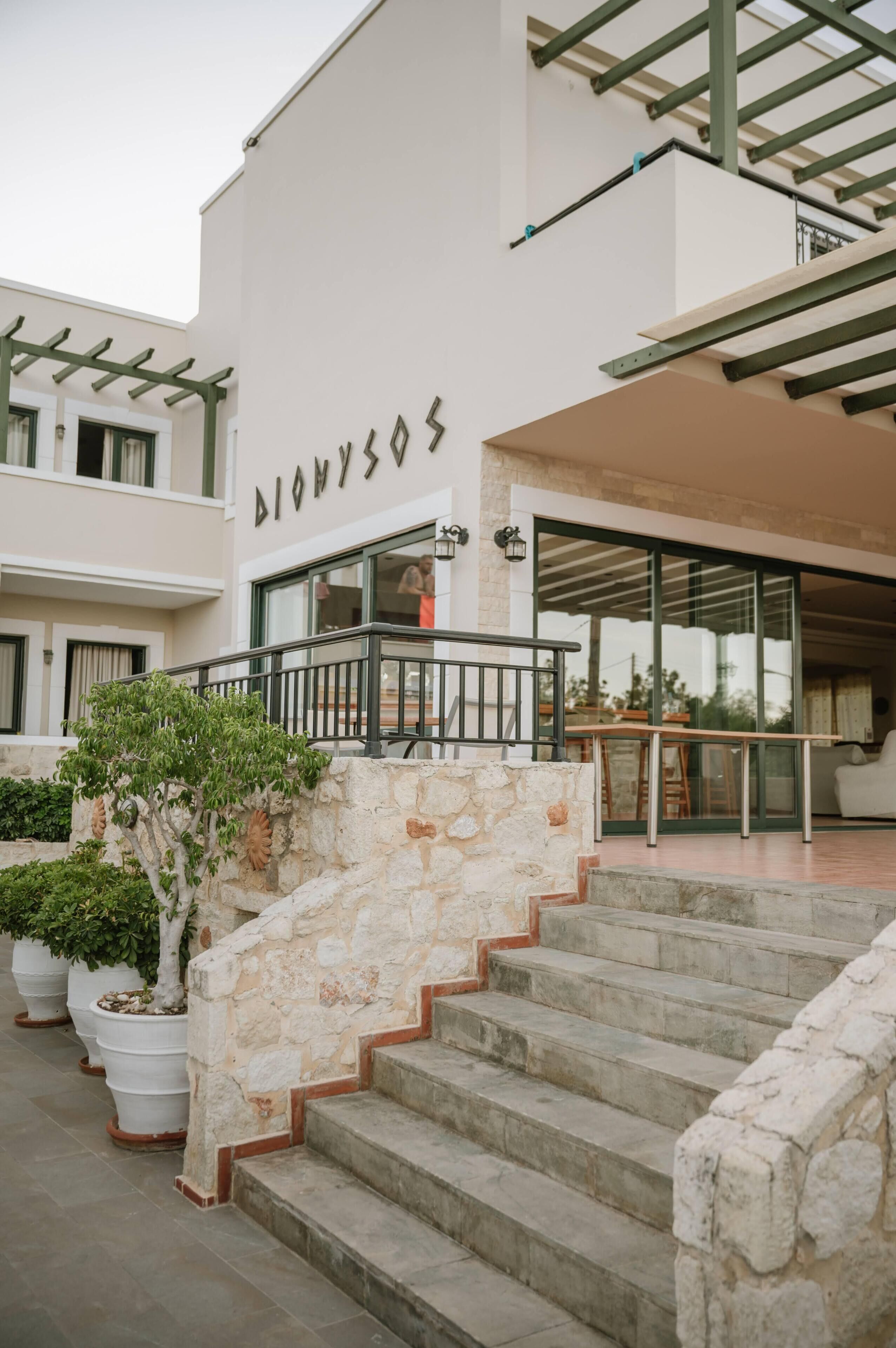A building with a stone staircase leading to a glass door entrance.