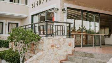 A building with a stone staircase leading to a glass door entrance.