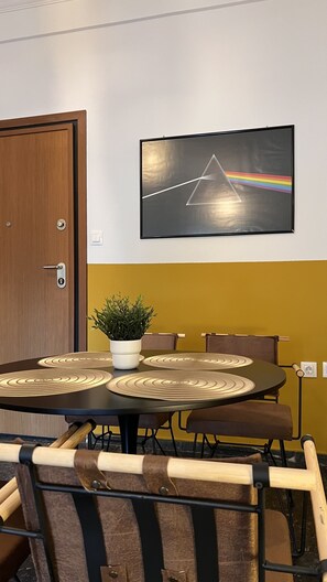 Conference room with a round table, black-framed TV, and comfortable seating for meetings.
