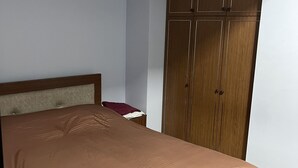 A bedroom with a bed, a wardrobe, and a nightstand. - Shartava 1 (Kutaisi)