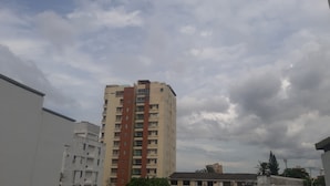 A multi-story residential building with balconies and a flat roof.