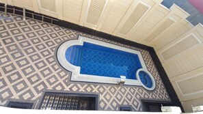 Featuring a unique blend of traditional and modern architectural elements, this space boasts intricate patterns, ornate windows, and geometric tile designs.