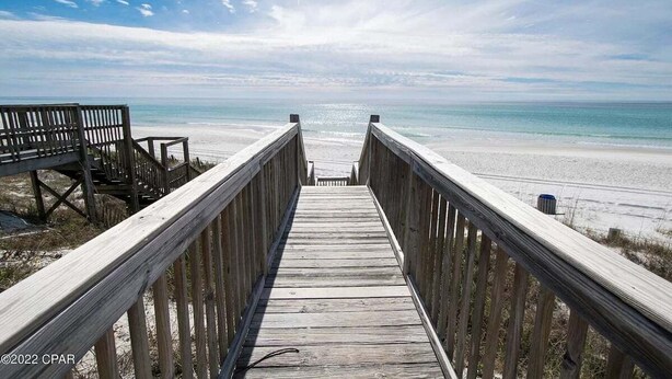 A wooden boardwalk leading to a beach with a clear view of the ocean. - 3 mins walk to Beach! Guest Beachfront Pool! (Panama City Beach)