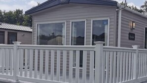 Ein eingeschossiges Gebäude mit einer weißen Terrasse und einem Schild, auf dem 'Bungalow' steht.