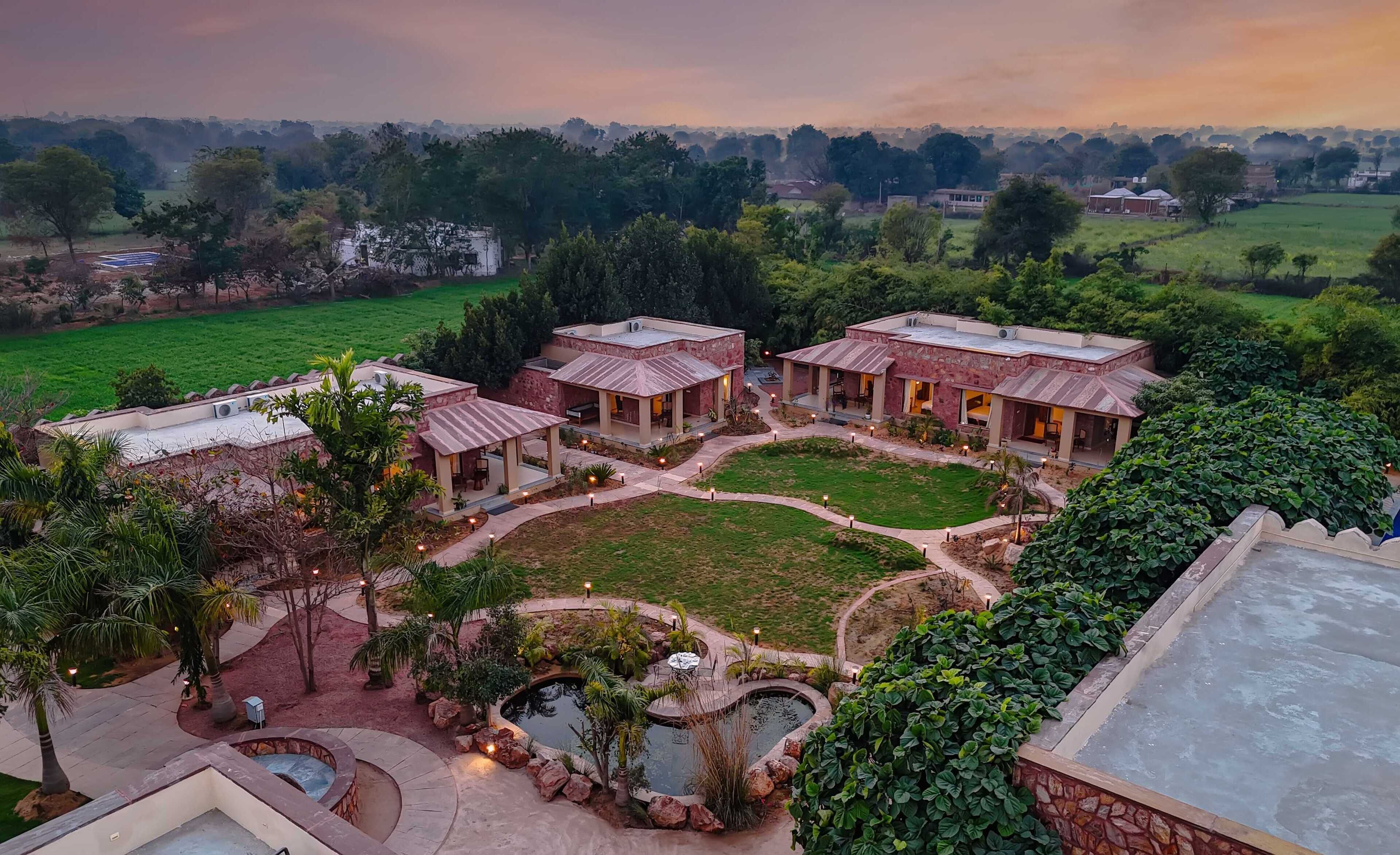 A resort with multiple villas, a central courtyard, and a swimming pool.
