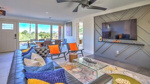 A modern living room with a leather sofa, glass coffee table, and a ceiling fan. - Charming Tucson Vacation Rental: 2 Mi to Downtown (Tucson)