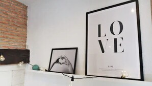 A wall with two framed pictures, one with the word 'LOVE' and another with a heart shape.