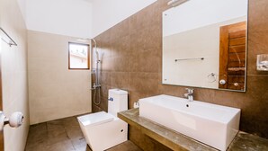 A modern bathroom with a large mirror, a bathtub, and a shower area. - White House 101 (Galle)