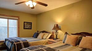 A bedroom with two beds, a window, a ceiling fan, a lamp, and a framed picture on the wall. - Canyons View 7: 2 Bedroom 2 bath vacation condo (Park City)