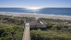 A wooden deck leading to a beach with a clear view of the ocean. - 4 BDR-Ocean Front Townhome in Pine Knoll Shores (Oceans 2) (Pine Knoll Shores)