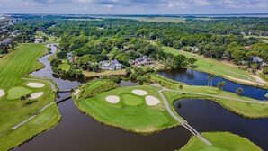 A golf course with water hazards, sand bunkers, and a bridge. - Golf and Ocean Views, 6 seat golf cart included (Fripp Island)