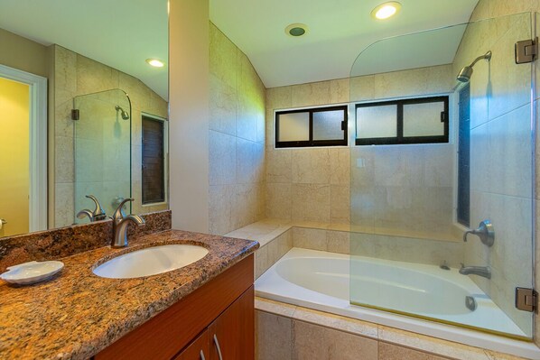 A bathroom with a granite countertop sink, a glass-enclosed shower, and a bathtub. - Summer Deal Maui Ocean View Villa with Pool BBQ and Golf Nearby (Lahaina)