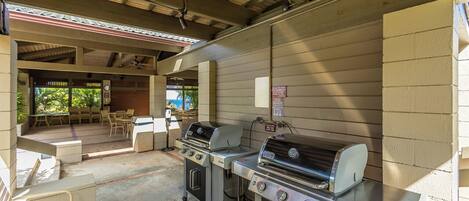 Covered outdoor grills ready for your cookout, with a breezy pavilion just beyond—perfect for gathering with friends and family.