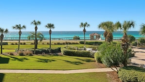 A coastal view with a pathway, palm trees, and a gazebo overlooking the sea. - Ground Floor Condo with Gorgeous Views (Miramar Beach)