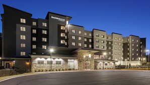 A multi-story hotel with a modern design, featuring a stone facade and multiple balconies. - Residence Inn by Marriott Homewood Mountain Brook (Birmingham)