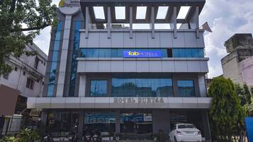 A hotel with a modern facade, a sign for 'fabHOTELS', and a visible entrance.