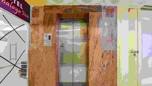 An elevator with a sign above it that reads "HOTEL MALAYA Inn". - FabExpress Himalaya Inn - Inside Himalaya Mall (Ahmedabad)