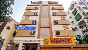 A multi-story building with a sign for 'D Grand Residency' and 'fab hotels'. - Fabexpress D Grand (Hyderabad)