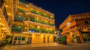 A multi-story hotel with balconies, a sign for 'fabHOTELS', and potted plants in the foreground. - FabHotel Surya Palace 2 (Chandigarh)