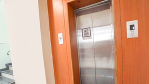 An elevator with a sign stating "No Outside Food Allowed" and a control panel on the wall. - Fabhotel Hrg Destiny (Nagpur)