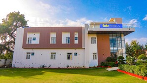 A modern building with a sign reading "fabHOTELS" on the upper right side. - Fabhotel The Avr Grand (Lucknow)