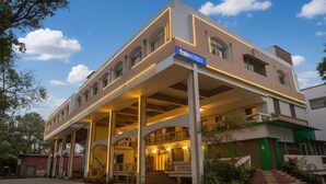 A hotel with a modern design, featuring a prominent entrance with a covered walkway and a sign reading "fabHOTELS". - FabHotel Om Sai I (Nashik)