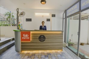 A reception desk with a sign for 'Fab Express' and 'Benz Destination'. - FabHotel Benz Destination (Candolim)