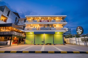 A multi-story hotel with a 'fabexpress' sign, a reception area, and a 'Benz Destination' sign. - FabHotel Benz Destination (Candolim)