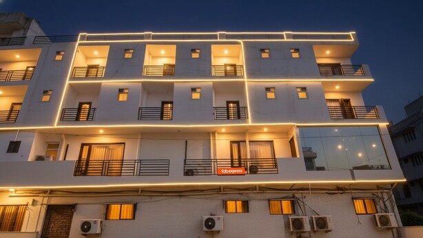 A multi-story hotel with balconies, air conditioning units, and a sign for 'Fabexpress'. - FabExpress The Premium Villa (New Delhi)