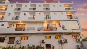 A multi-story building with balconies, air conditioning units, and a sign for 'FabExpress'. - FabExpress The Premium Villa (New Delhi)