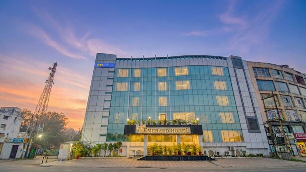A hotel with a modern glass facade, a prominent entrance, and a sign for 'Emerald Hotel'. - Fabhotel Emerald (Ranchi)