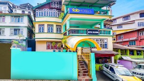 A multi-story hotel with a prominent 'fabHOTELS' sign, a staircase entrance, and a visible 'Hotel Siling' sign. - Fabhotel Siljong (Gangtok)