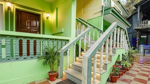 A staircase with white balusters, a green exterior wall, and potted plants at the base. - Via Jesant Valley Resort - Nr. Candolim Beach (Candolim)