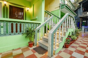 A staircase with white balusters, a green exterior wall, and potted plants at the base. - Via Jesant Valley Resort - Nr. Candolim Beach (Candolim)