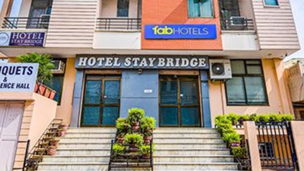 A multi-story hotel with a sign for 'Hotel Stay Bridge' and 'Fab Hotels'. - Fabhotel Aayojan (Jaipur)