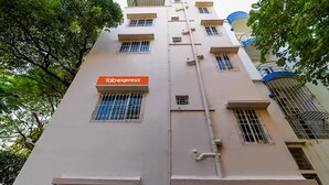 A building with a 'Fabexpress' sign on the facade, multiple windows, and a visible pipe running vertically. - Fabexpress Golden Palace (Kolkata)