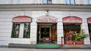 A hotel entrance with a sign reading "HOTEL THREE STAR" and a sign for "LODGING & BOARDING RESTAURANT & BANQUET" on either side. - Fabhotel Prime Three Star (Panvel)