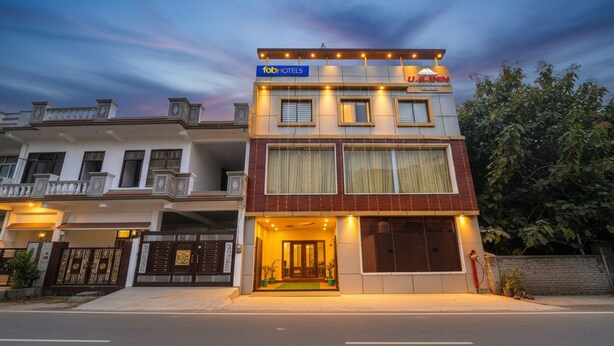 A two-story building with a sign for 'FabHotels' and 'J. Binn'.