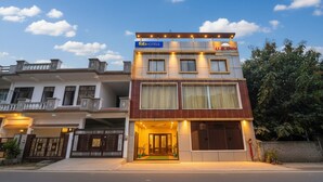 A two-story building with a sign for 'fabHOTELS' and 'UBINN'.