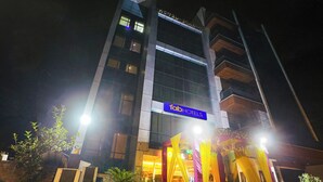 A multi-story building with a sign for 'Fab Hotels'. - FabHotel Green Lotus Star 17 (New Delhi)