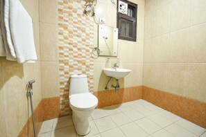 A bathroom with a toilet, sink, and shower. - FabHotel Royal Casa (Gurugram)