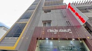 A hotel facade with a modern design, featuring a prominent sign with text and a logo. - Fabhotel Gateway Suites (Bengaluru)