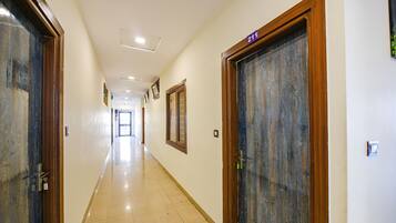 A hallway with doors labeled 203 and 211, leading to rooms.